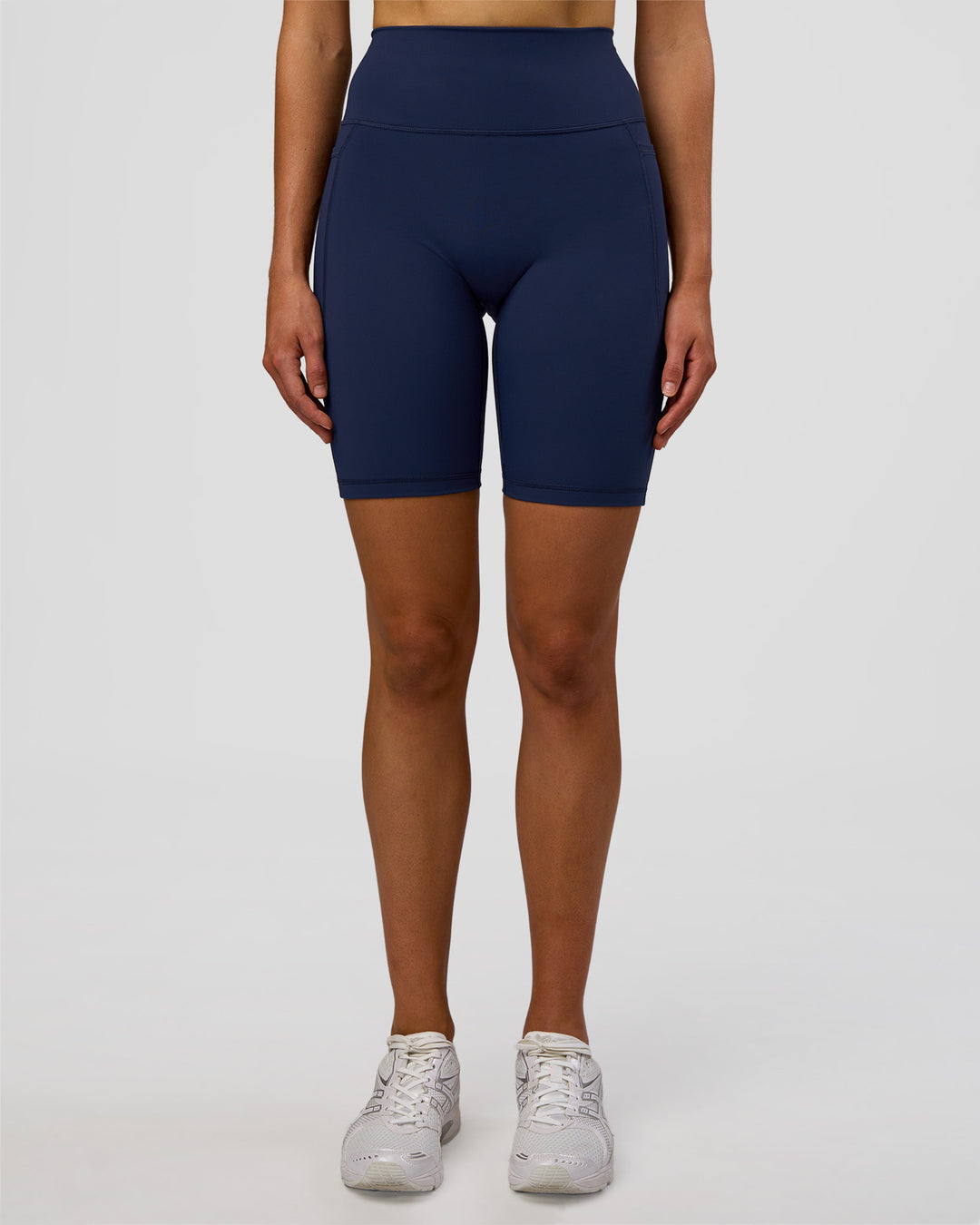 Woman wearing Fusion Ultra High-Rise 9&quot; Short Pockets - Future Navy | Model:Evie | Size:S