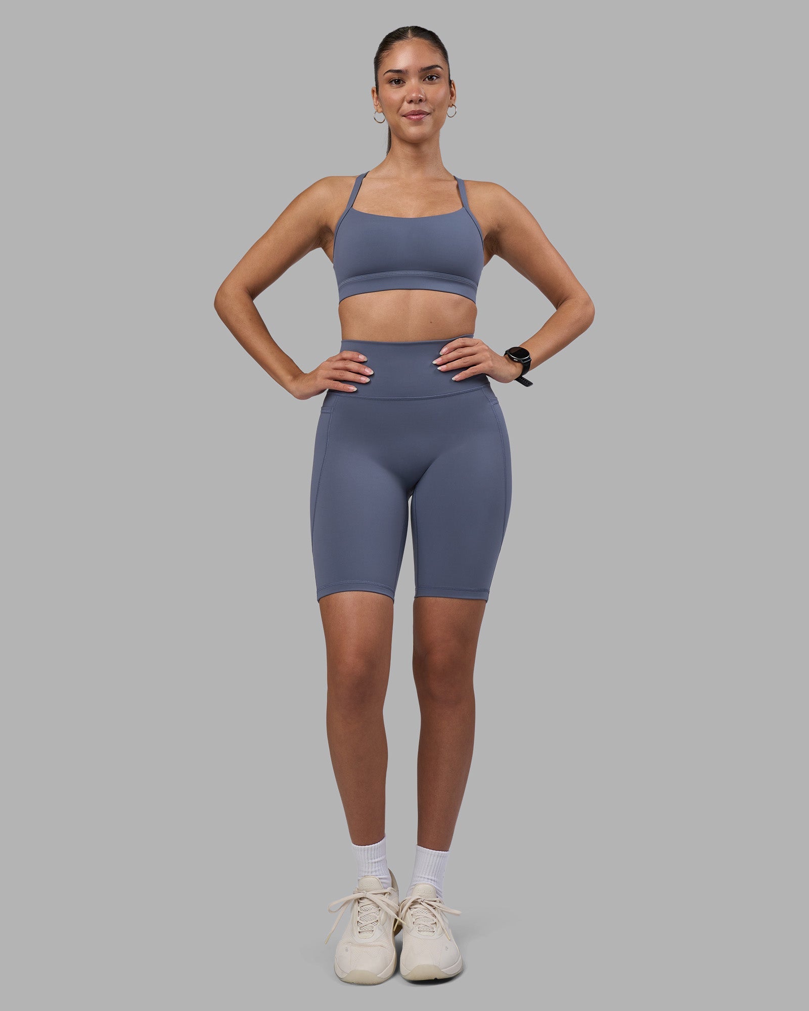 Woman wearing Fusion Ultra High-Rise 9" Short Pockets - Night Shadow | Model:Rhiley | Size:S