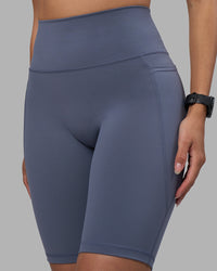 Woman wearing Fusion Ultra High-Rise 9" Short Pockets - Night Shadow | Model:Rhiley | Size:S