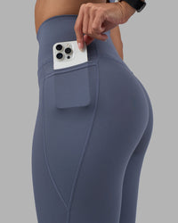 Woman wearing Fusion Ultra High-Rise 9" Short Pockets - Night Shadow | Model:Rhiley | Size:S