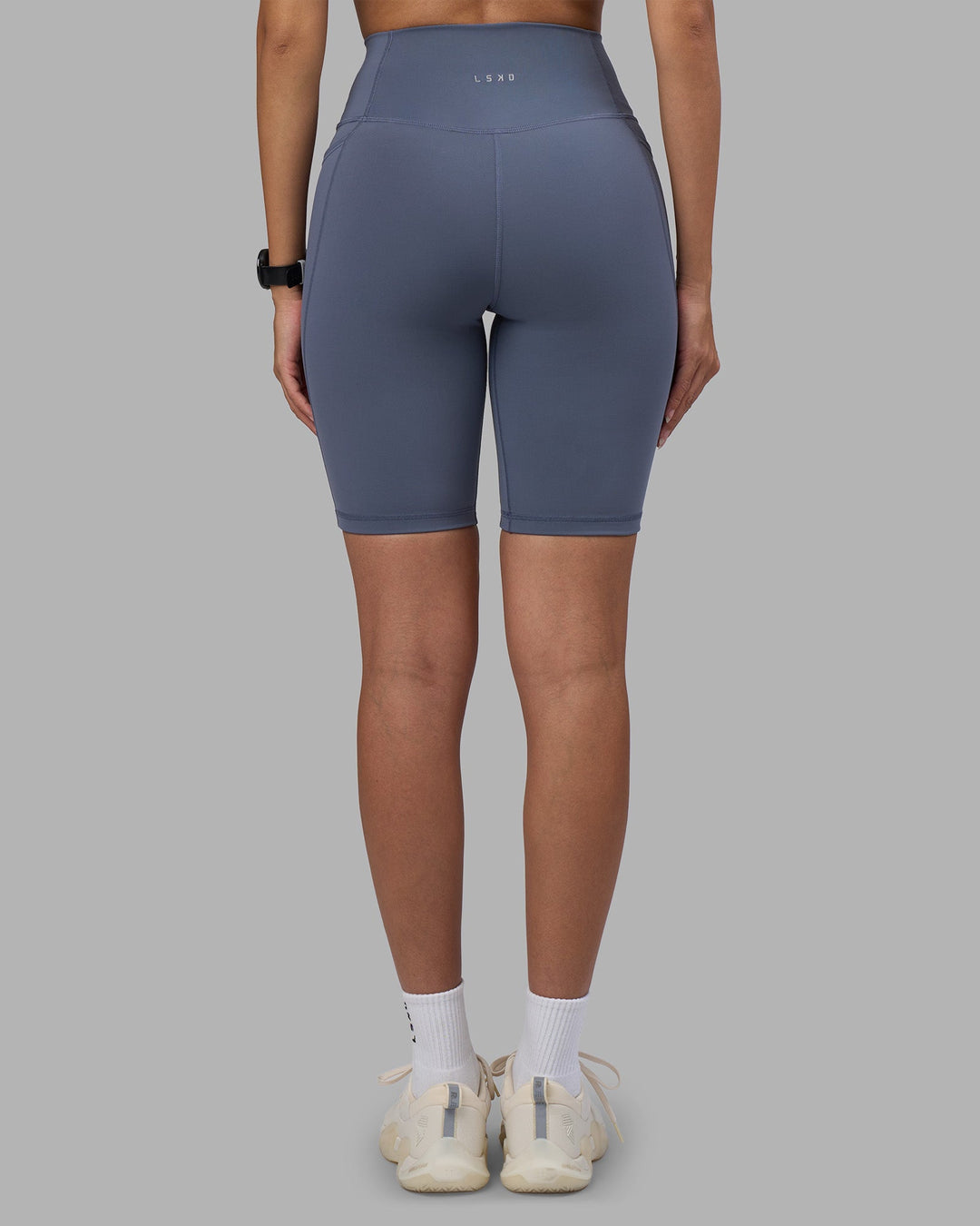 Woman wearing Fusion Ultra High-Rise 9" Short Pockets - Night Shadow | Model:Rhiley | Size:S