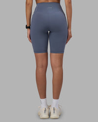 Woman wearing Fusion Ultra High-Rise 9" Short Pockets - Night Shadow | Model:Rhiley | Size:S