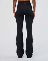 Woman wearing Fusion Ultra High-Rise Flared Tall Legging Pockets - Black | Model:Tomi | Size:S
