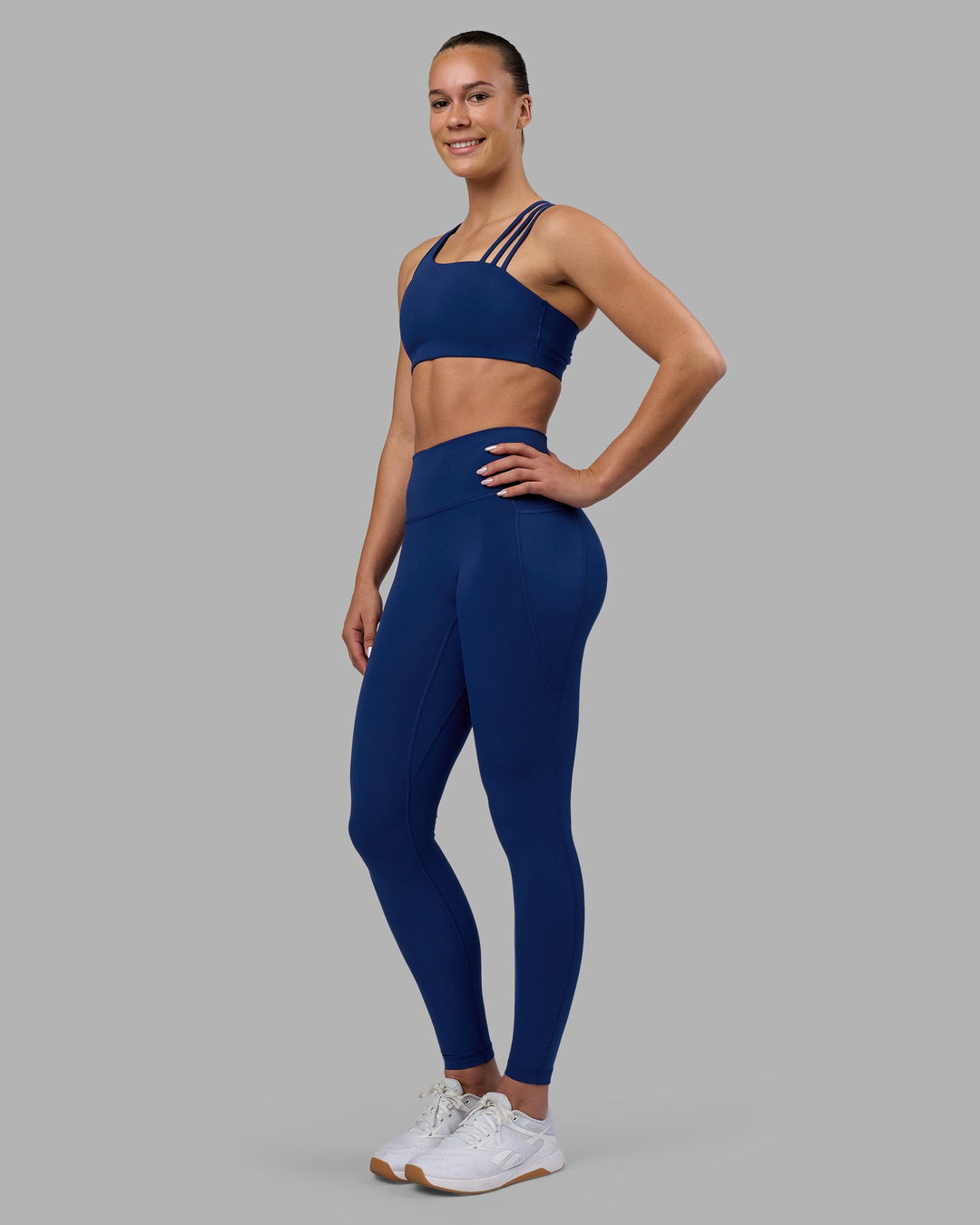Woman wearing Fusion Ultra High-Rise Full Length Legging Pockets - Midnight Blue | Model:Charlize | Size:S