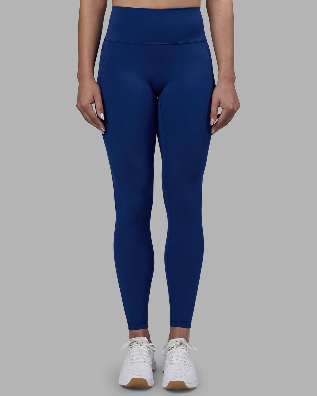 Woman wearing Fusion Ultra High-Rise Full Length Legging Pockets - Midnight Blue | Model:Charlize | Size:S