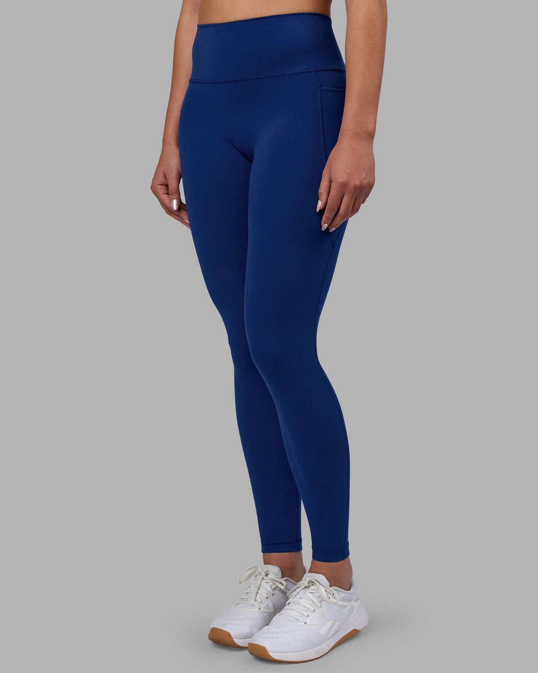 Woman wearing Fusion Ultra High-Rise Full Length Legging Pockets - Midnight Blue | Model:Charlize | Size:S