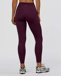 Woman wearing Fusion Ultra High-Rise Full Length Legging Pockets - Midnight Plum | Model:Amity | Size:S