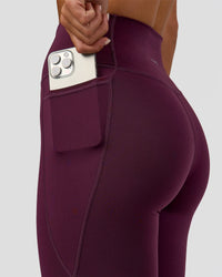 Woman wearing Fusion Ultra High-Rise Full Length Legging Pockets - Midnight Plum | Model:Amity | Size:S