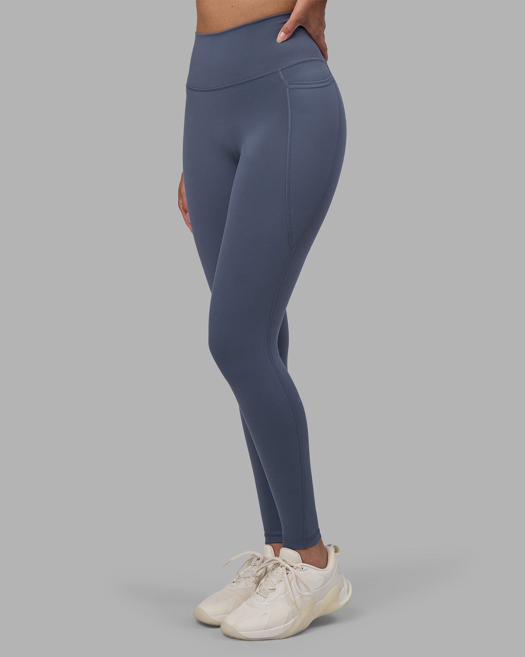 Woman wearing Fusion Ultra High-Rise Full Length Legging Pockets - Night Shadow | Model:Rhiley | Size:S