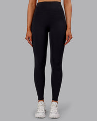 Woman wearing Fusion Ultra High-Rise Full Length Thermal Legging Pockets - Black | Model:Ella | Size:S