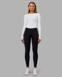 Woman wearing Fusion Ultra High-Rise Full Length Thermal Legging Pockets - Black | Model:Ella | Size:S