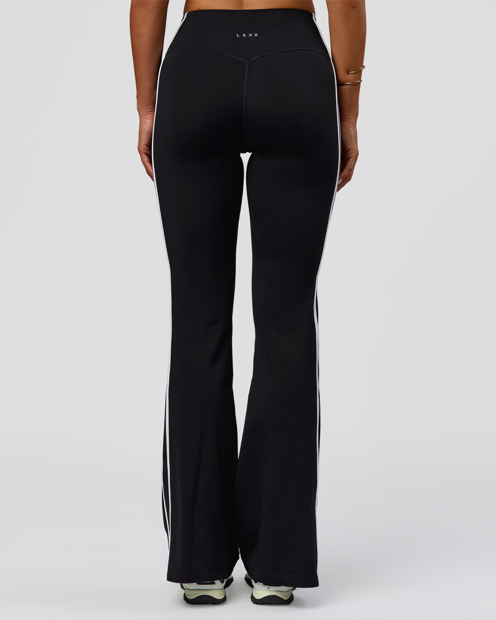 Woman wearing Fusion V-Contour Bind High-Rise Flared Legging - Black-white | Model:Bianca | Size:S
