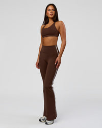 Woman wearing Fusion V-Contour Bind High-Rise Flared Legging - Hot Chocolate-white | Model:Bianca | Size:S