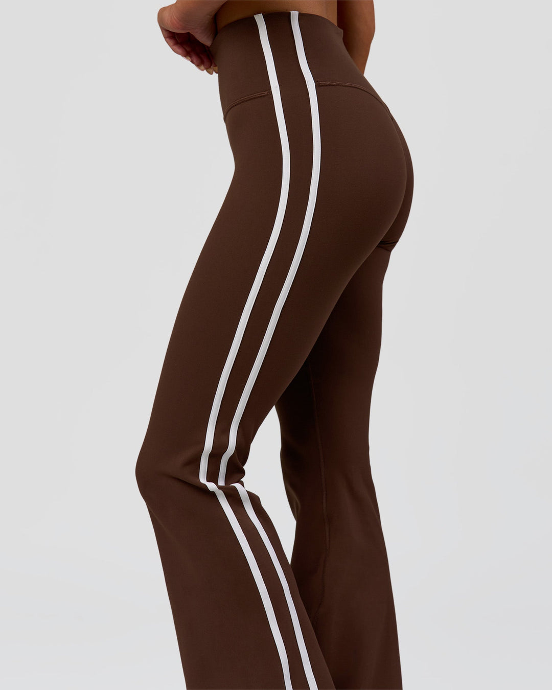 Woman wearing Fusion V-Contour Bind High-Rise Flared Legging - Hot Chocolate-white | Model:Bianca | Size:S