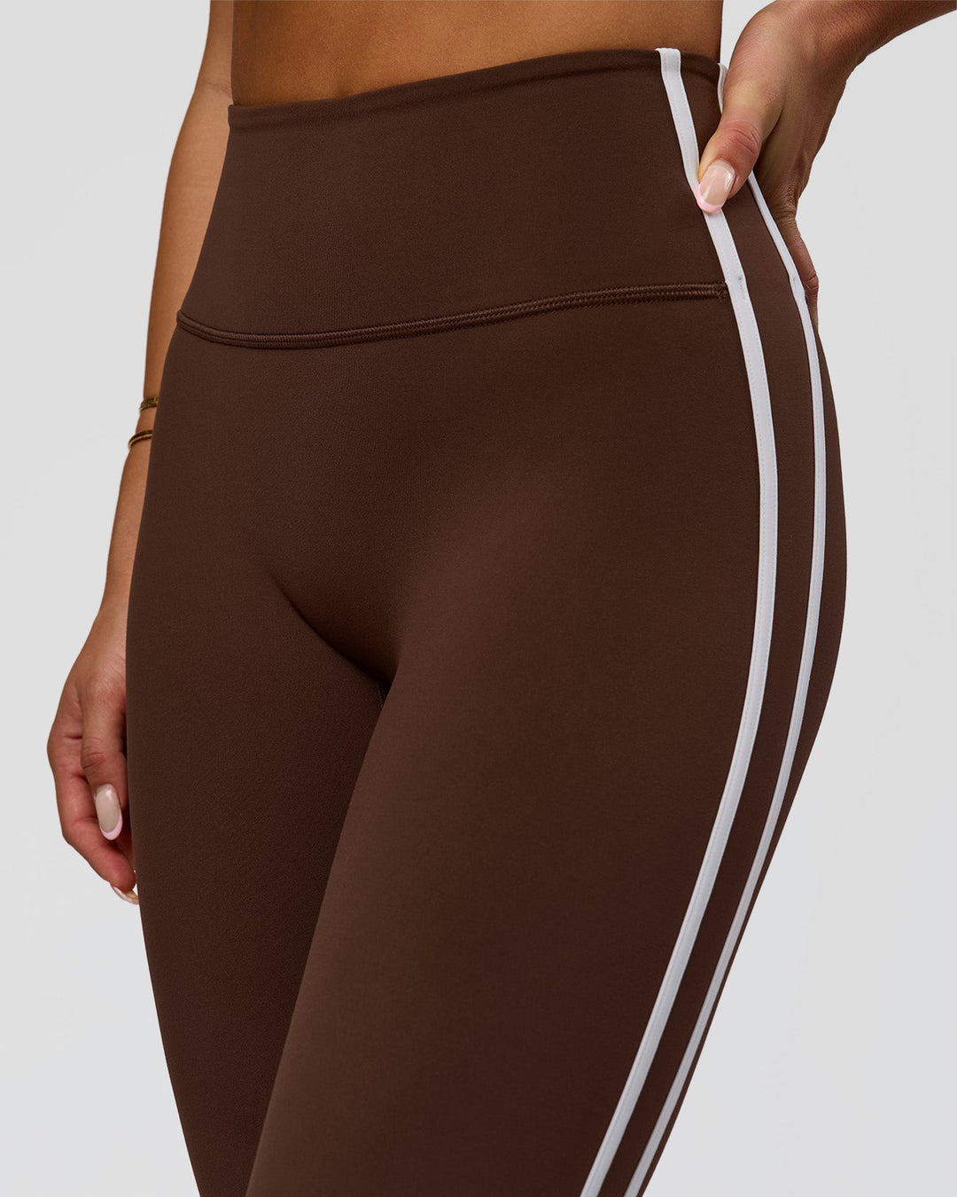 Woman wearing Fusion V-Contour Bind High-Rise Flared Legging - Hot Chocolate-white | Model:Bianca | Size:S