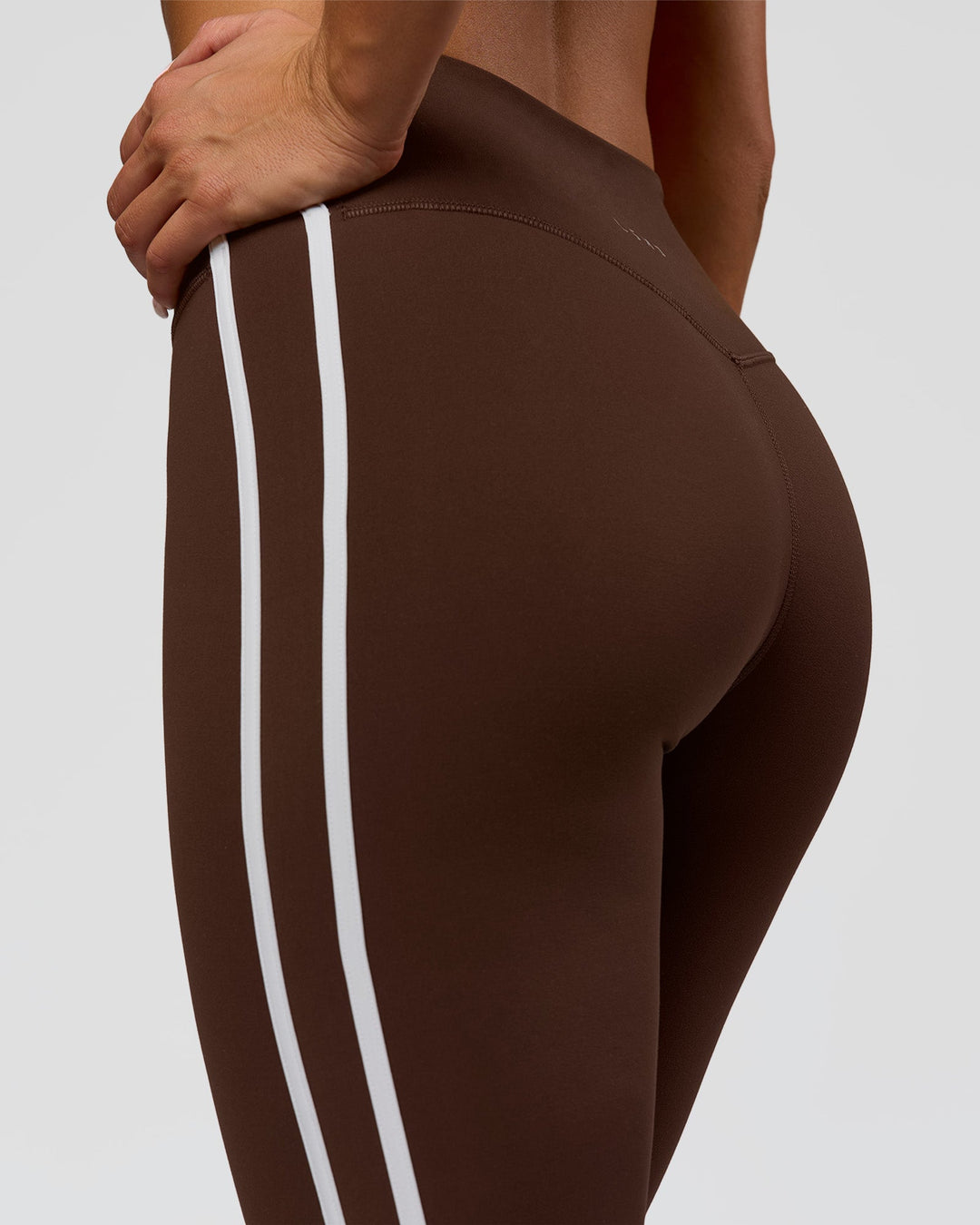 Woman wearing Fusion V-Contour Bind High-Rise Flared Legging - Hot Chocolate-white | Model:Bianca | Size:S