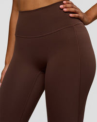 Woman wearing Woman wearing Fusion V-Contour High-Rise Flared Legging Pockets - Hot Chocolate | Model:Jordan | Size:S