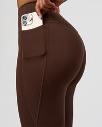 Woman wearing Woman wearing Fusion V-Contour High-Rise Flared Legging Pockets - Hot Chocolate | Model:Jordan | Size:S