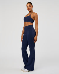 Woman wearing Fusion V-Contour High-Rise Flared Tall Legging Pockets - Future Navy | Model:Rosie | Size:S