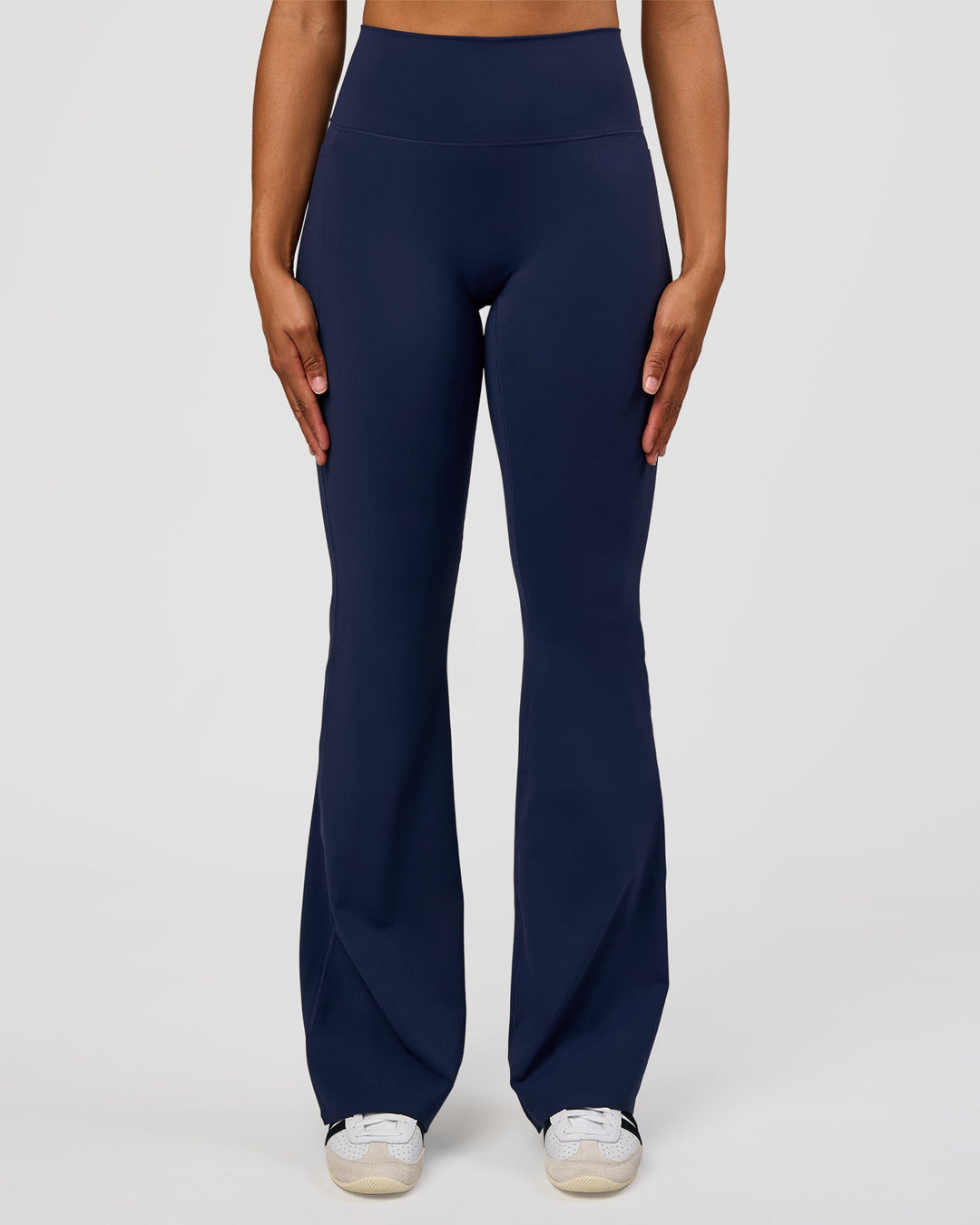Woman wearing Fusion V-Contour High-Rise Flared Tall Legging Pockets - Future Navy | Model:Rosie | Size:S