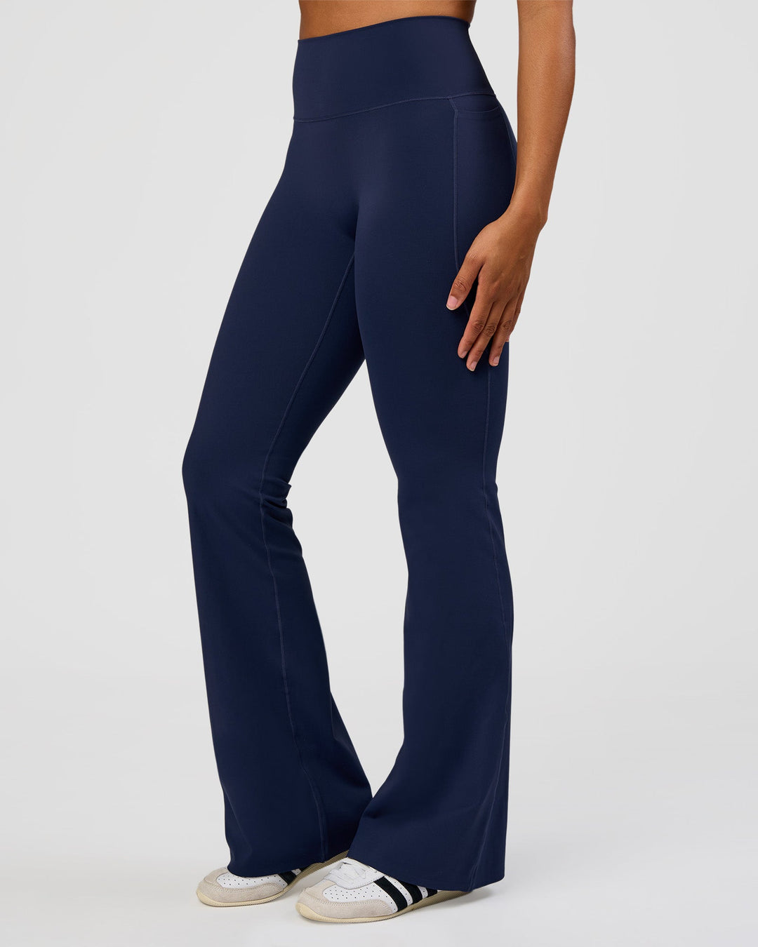 Woman wearing Fusion V-Contour High-Rise Flared Tall Legging Pockets - Future Navy | Model:Rosie | Size:S