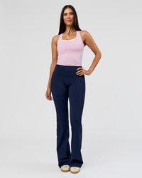 Woman wearing Fusion V-Contour High-Rise Flared Tall Legging Pockets - Future Navy | Model:Rosie | Size:S