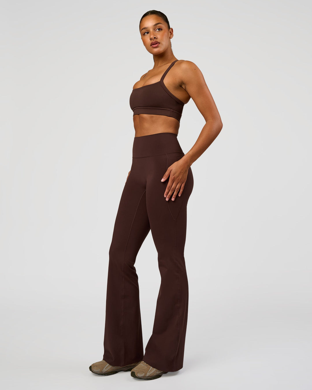 Woman wearing Fusion V-Contour High-Rise Flared Tall Legging Pockets - Hot Chocolate | Model:Rosie | Size:S