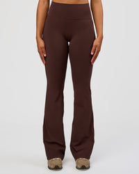 Woman wearing Fusion V-Contour High-Rise Flared Tall Legging Pockets - Hot Chocolate | Model:Rosie | Size:S