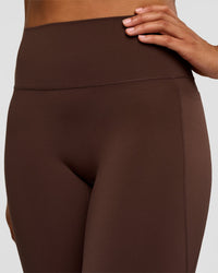 Woman wearing Fusion V-Contour High-Rise Flared Tall Legging Pockets - Hot Chocolate | Model:Rosie | Size:S