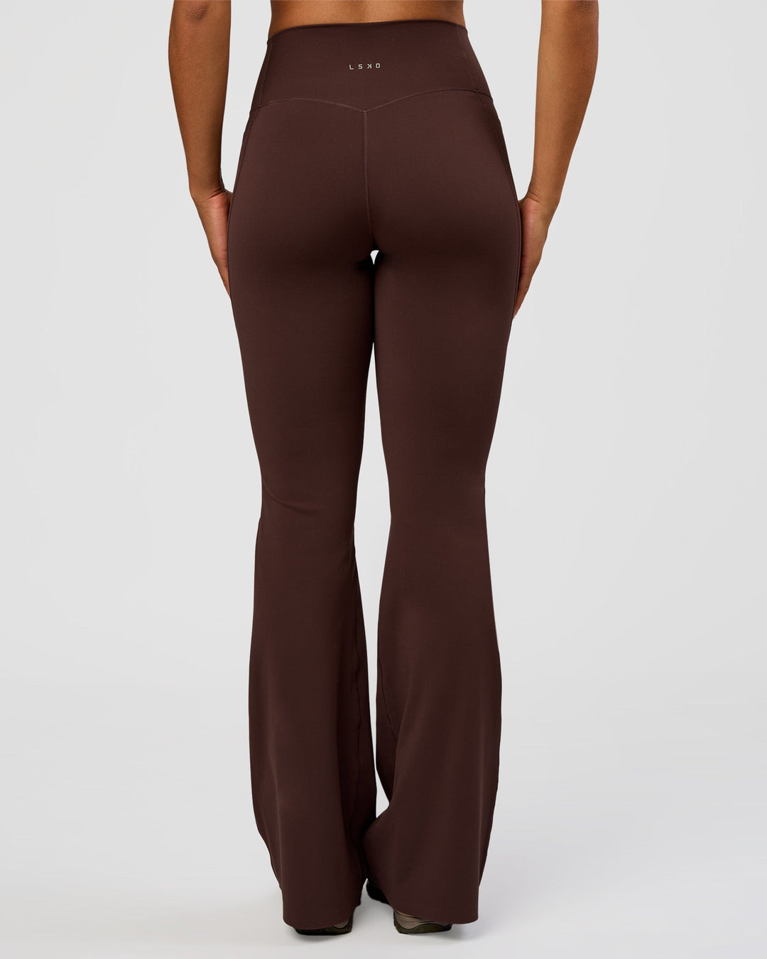 Woman wearing Fusion V-Contour High-Rise Flared Tall Legging Pockets - Hot Chocolate | Model:Rosie | Size:S