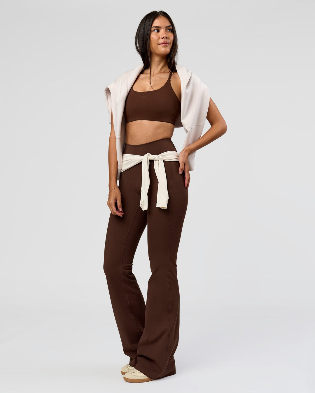 Woman wearing Fusion V-Contour High-Rise Flared Tall Legging Pockets - Hot Chocolate | Model:Rhiley | Size:S