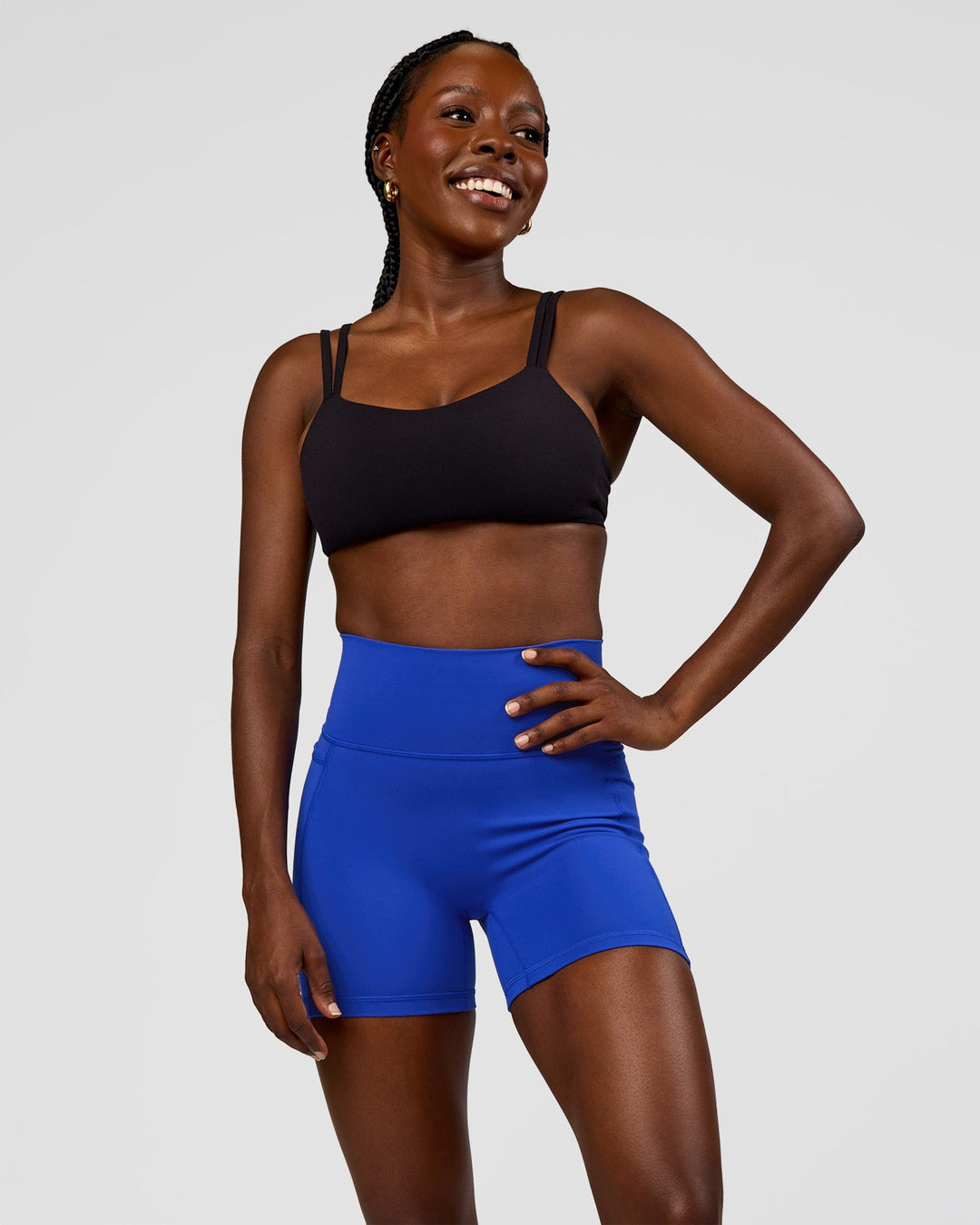 Woman wearing Fusion V-Contour Ultra High-Rise 4” Short Pockets - Electric Indigo | Model:Ellie | Size:S