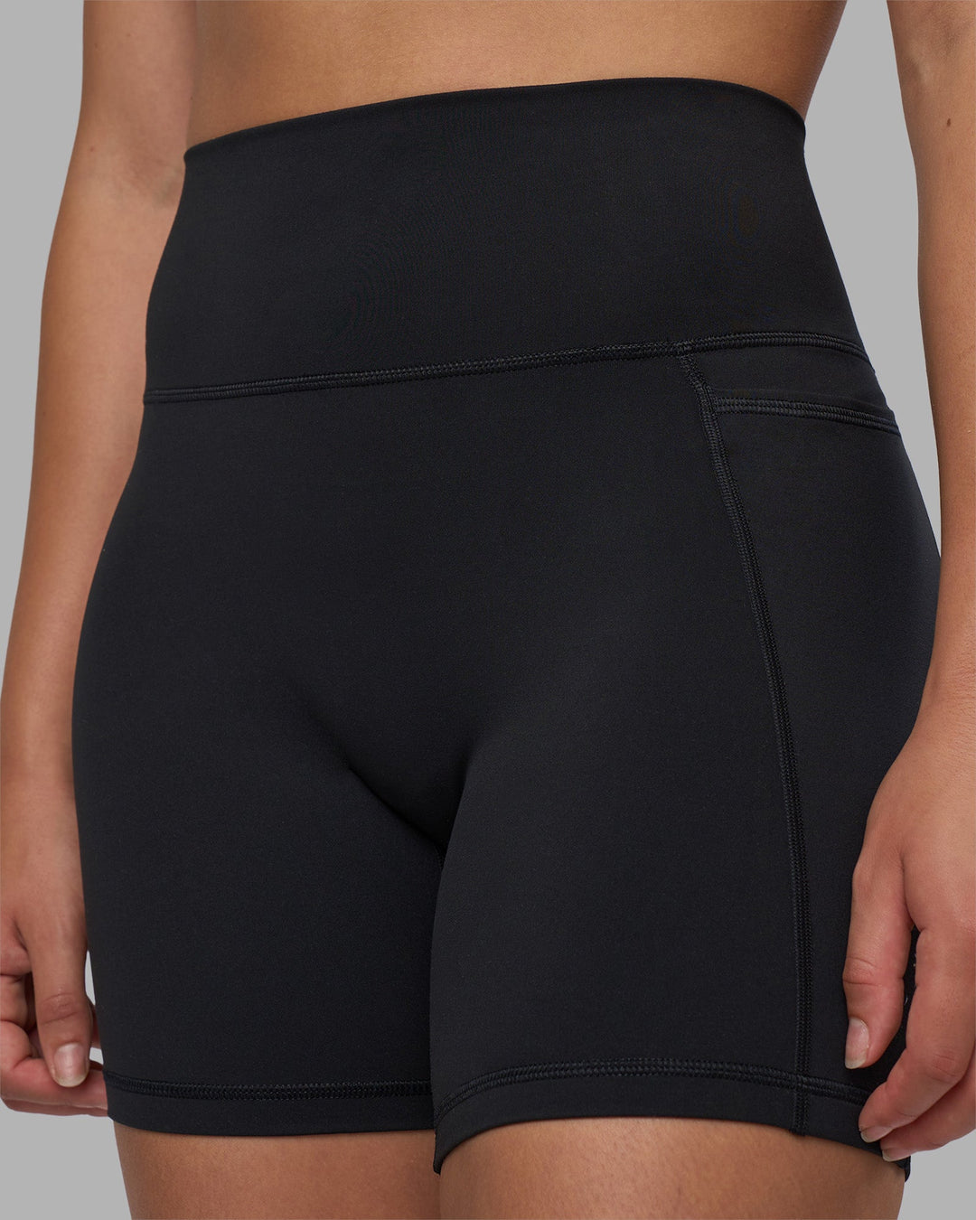 Woman wearing Fusion V-Contour Ultra High-Rise 6" Short Pockets - Black | Model:Charlize | Size:S