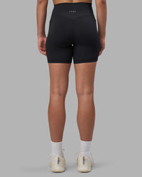 Woman wearing Fusion V-Contour Ultra High-Rise 6" Short Pockets - Black | Model:Charlize | Size:S