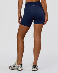 Woman wearing Fusion V-Contour Ultra High-Rise 6" Short Pockets - Future Navy 
| Model:Amity | Size:S