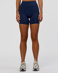 Woman wearing Fusion V-Contour Ultra High-Rise 6" Short Pockets - Future Navy 
| Model:Amity | Size:S