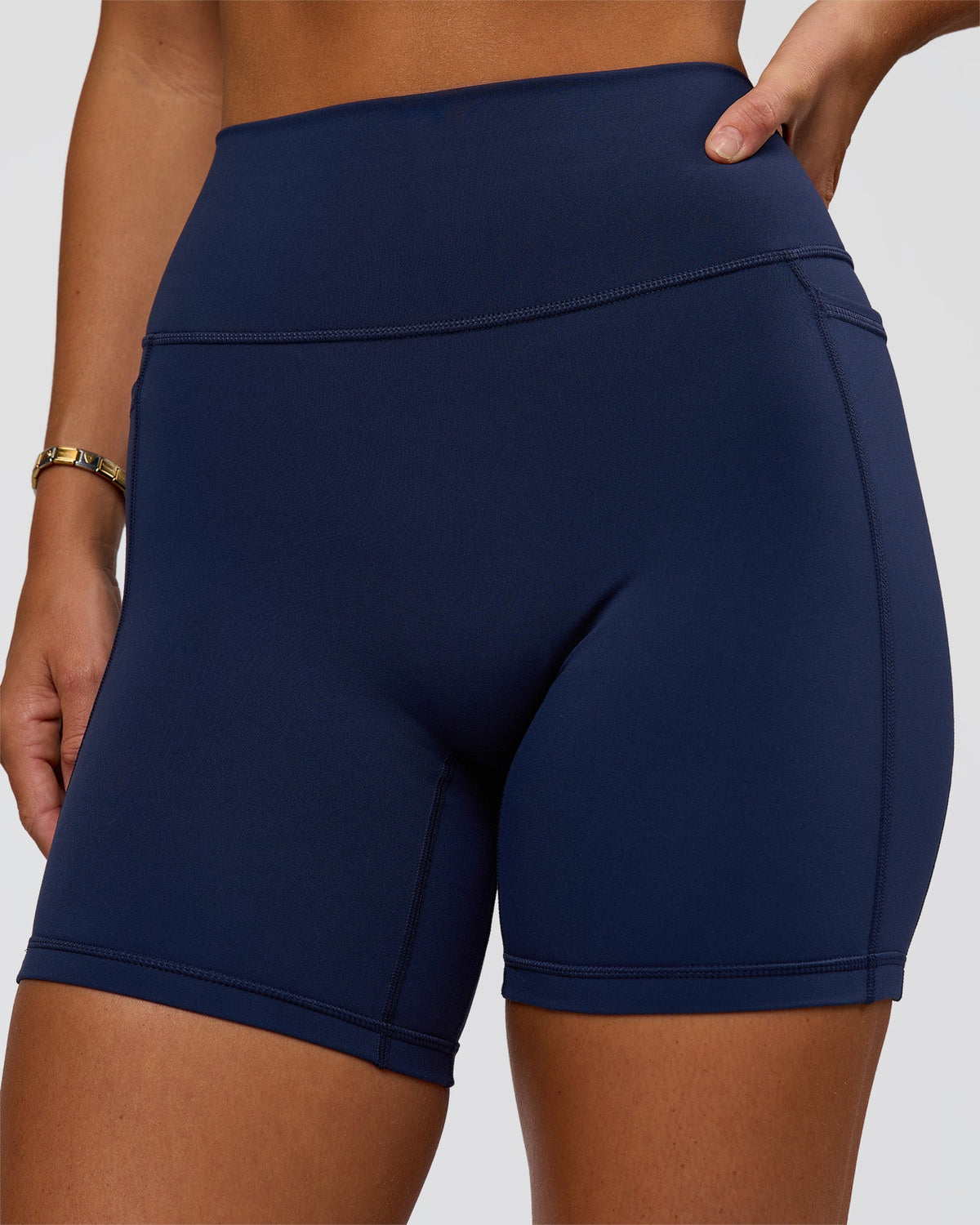 Woman wearing Fusion V-Contour Ultra High-Rise 6" Short Pockets - Future Navy 
| Model:Amity | Size:S