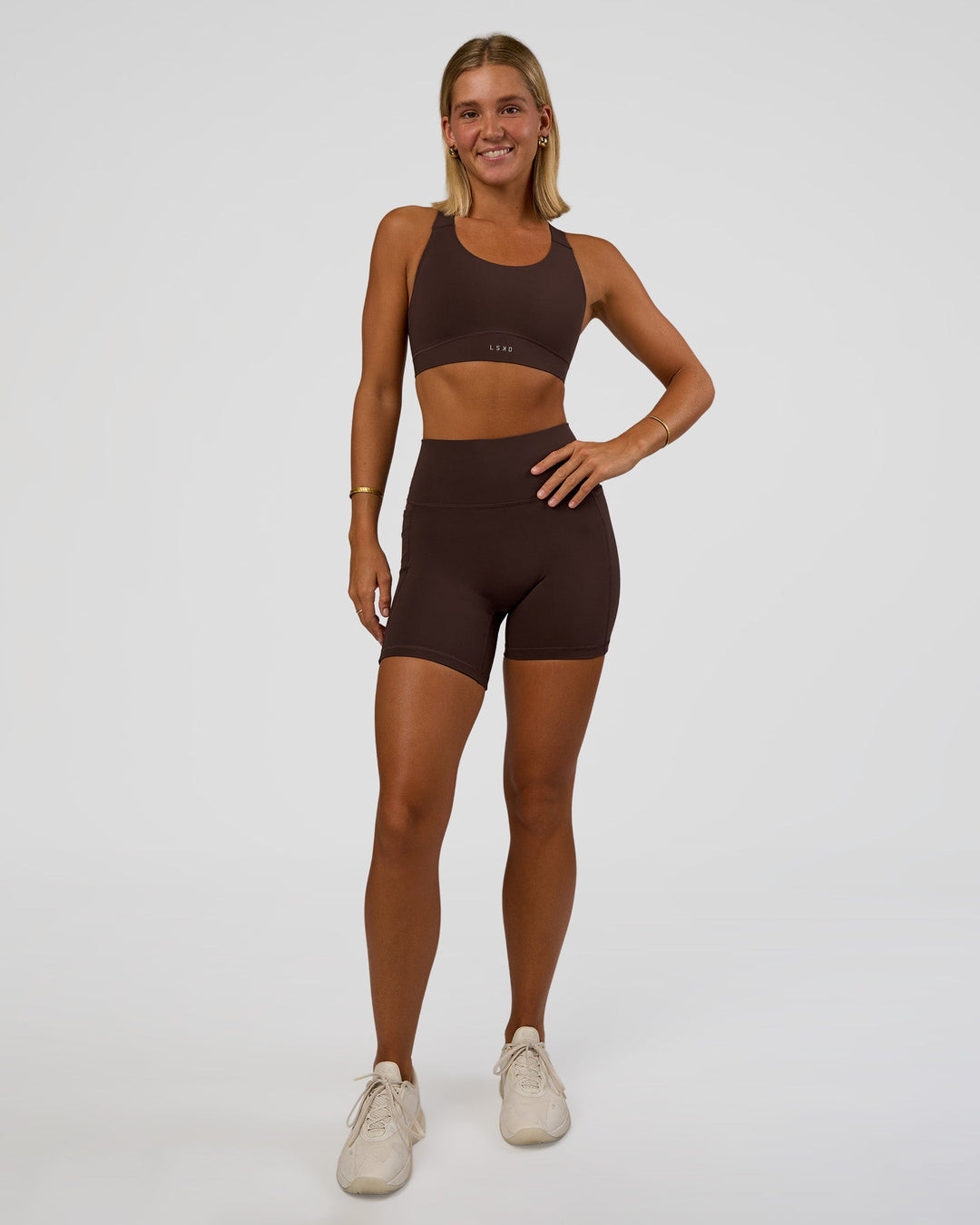 Woman wearing Fusion V-Contour Ultra High-Rise 6&quot; Short Pockets - Hot Chocolate | Model:Amity | Size:S