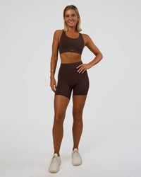 Woman wearing Fusion V-Contour Ultra High-Rise 6" Short Pockets - Hot Chocolate | Model:Amity | Size:S