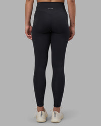 Woman wearing Fusion V-Contour Ultra High-Rise Full Length Legging Pockets - Black | Model:Charlize | Size:S