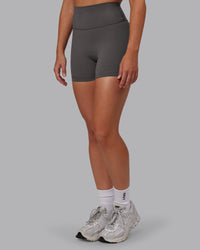 Woman wearing Fusion Ultra High-Rise 4" Short - Dark Storm | Set:true | Angle:side | Model:Hannah | Size:S