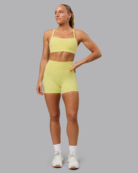 Woman wearing Fusion Ultra High-Rise 4" Short Pockets - Lemon Fizz | Model:Shalem | Size:S | Thumbnail Index: 0