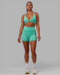 Woman wearing Fusion Ultra High-Rise 4" Short Pockets - Aquatic Awe | Model:Gabby | Size:S