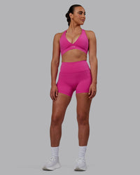 Woman wearing Fusion Ultra High-Rise 4" Short Pockets - Fuchsia Pink | Model:Sophie | Size:S