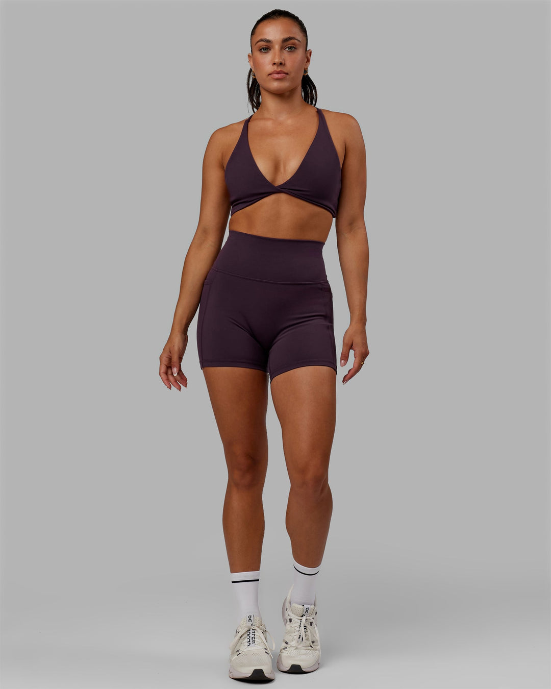Woman wearing Fusion Ultra High-Rise 4" Short Pockets - Midnight Plum | Model:Gabby | Size:S