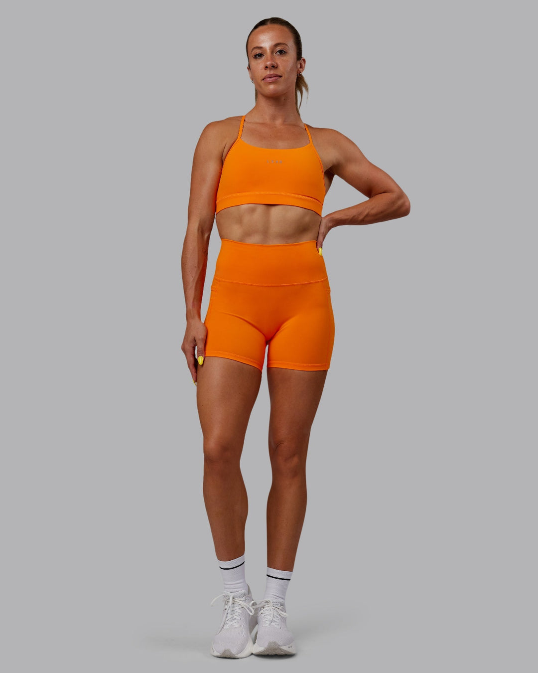 Woman wearing Fusion X-Length Shorts - Vibrant Orange