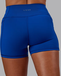 Woman wearing Fusion Ultra High-Rise 4" Short Pockets - Blue Quartz | Model:Phoebe | Size:S
