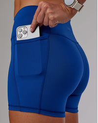Woman wearing Fusion Ultra High-Rise 4" Short Pockets - Blue Quartz | Set:true | Angle:closeup | Model:Phoebe | Size:S