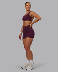 Woman wearing Fusion Ultra High-Rise 4" Short Pockets - Cherry Lacquer | Model:Lyss | Size:S