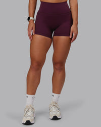 Woman wearing Fusion Ultra High-Rise 4" Short Pockets - Cherry Lacquer | Set:true | Angle:front | Model:Lyss | Size:S